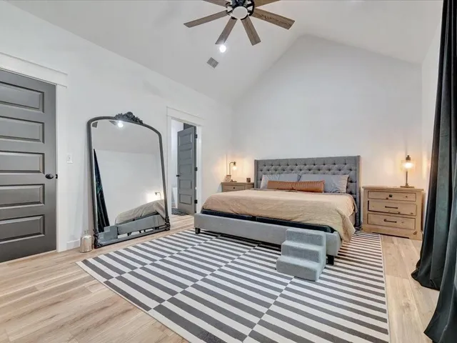 a bedroom with a bed a rug and dresser