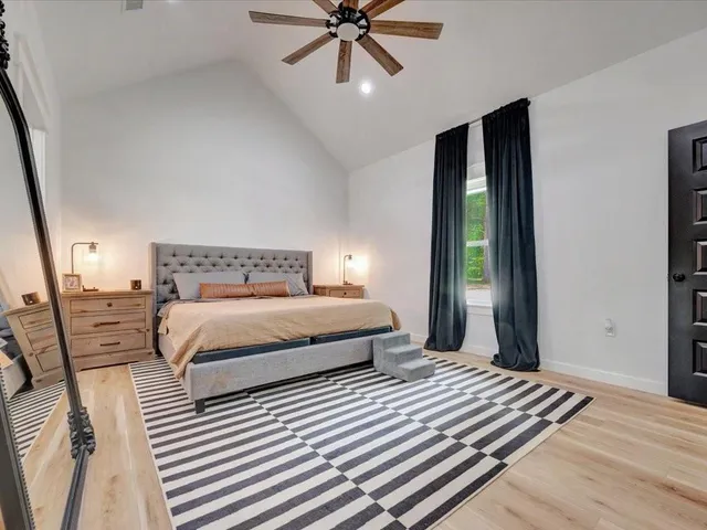 a bedroom with a bed and a large window