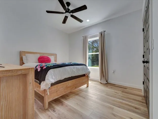 a bedroom with a bed and a window