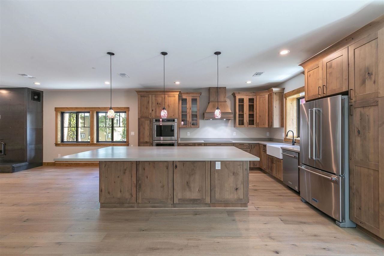 15611 Conifer Drive Truckee, CA 96161 - Photo 16 of 20 a large kitchen with stainless steel appliances kitchen island granite countertop a refrigerator a stove a sink and a wooden floors