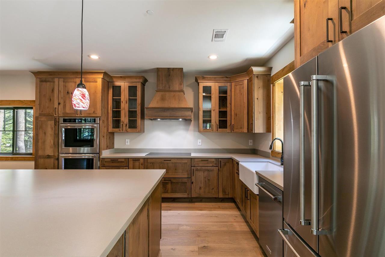 15611 Conifer Drive Truckee, CA 96161 - Photo 17 of 20 a view of a kitchen with kitchen island a counter top space a sink stainless steel appliances and cabinets