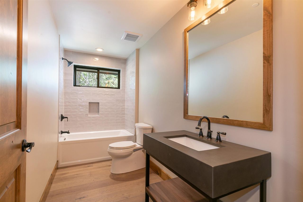 15611 Conifer Drive Truckee, CA 96161 - Photo 8 of 20 a bathroom with a toilet a sink and a mirror