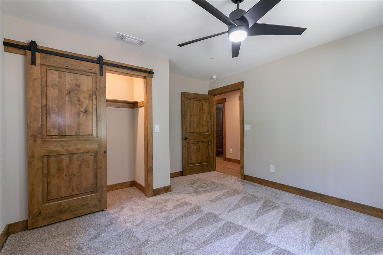 15611 Conifer Drive Truckee, CA 96161 - Photo 10 of 20 an empty room with closet and a chandelier fan