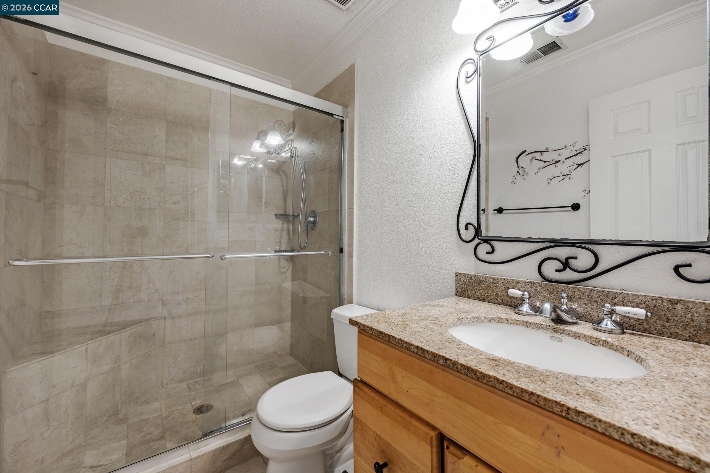 1544 Bailey Road, Unit 30 Concord, CA 94521 - Photo 25 of 33 a bathroom with a granite countertop sink toilet and shower
