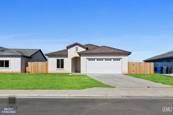 a front view of house with yard and garage