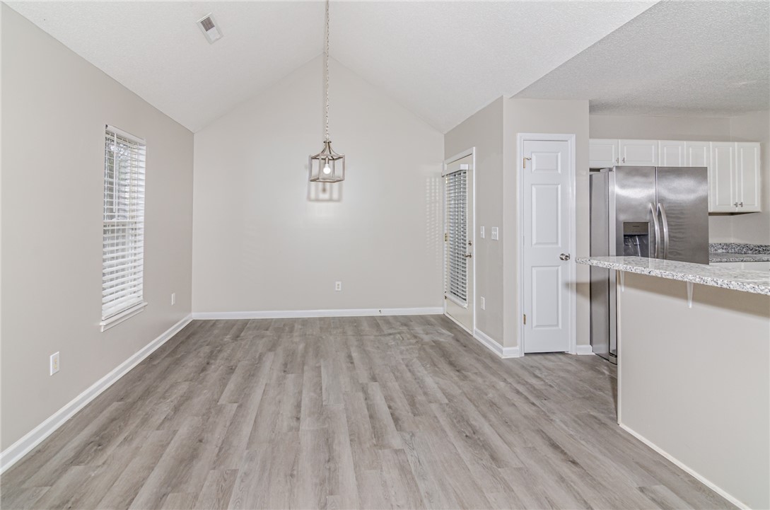 102 Hawk Ridge Drive Anderson, SC 29621 - Photo 9 of 38 This versatile space features high ceilings, durable flooring, and a luminous kitchen area, perfect for daily living.