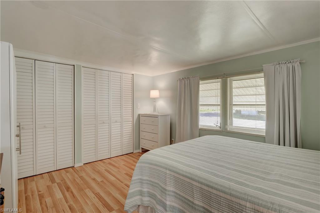104 Willow Lane, Unit 30 Naples, FL 34114 - Photo 12 of 27 a bedroom with a bed and a window