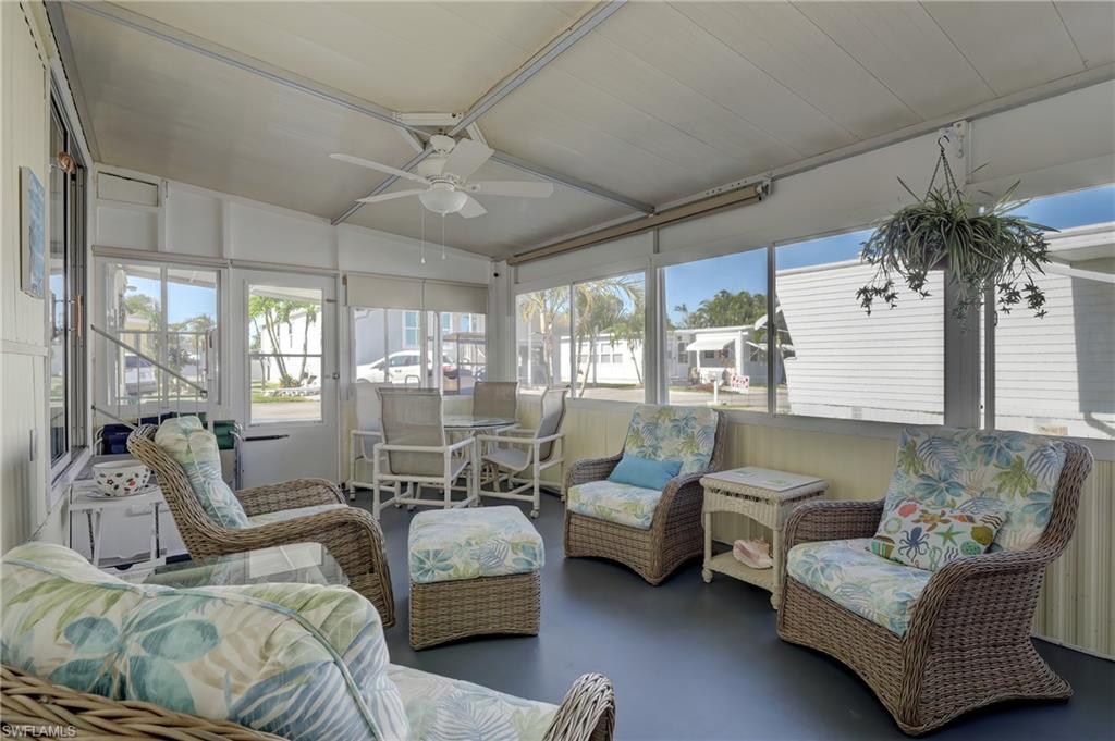 104 Willow Lane, Unit 30 Naples, FL 34114 - Photo 14 of 27 a bedroom with furniture and a large window