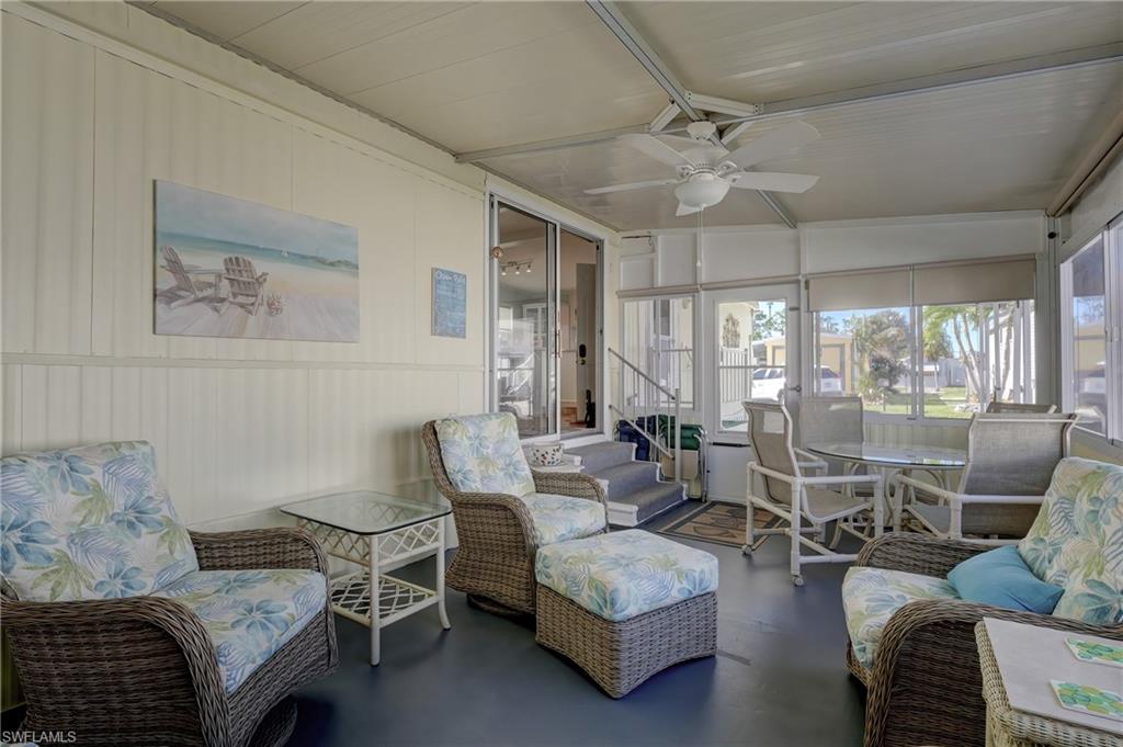 104 Willow Lane, Unit 30 Naples, FL 34114 - Photo 15 of 27 a living room with furniture and a large window