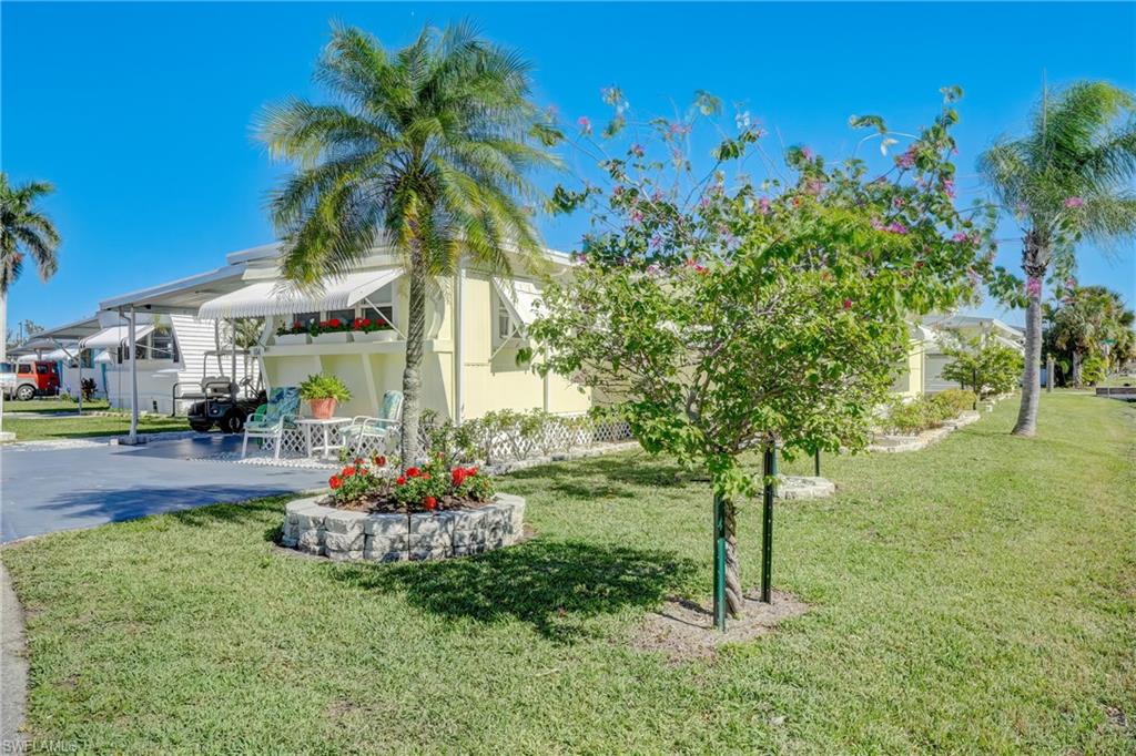 104 Willow Lane, Unit 30 Naples, FL 34114 - Photo 18 of 27 a front view of a house with a yard
