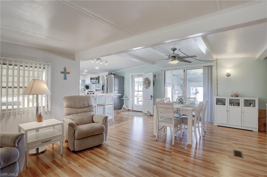 104 Willow Lane, Unit 30 Naples, FL 34114 - Photo 2 of 27 a living room with furniture wooden floor and a large window