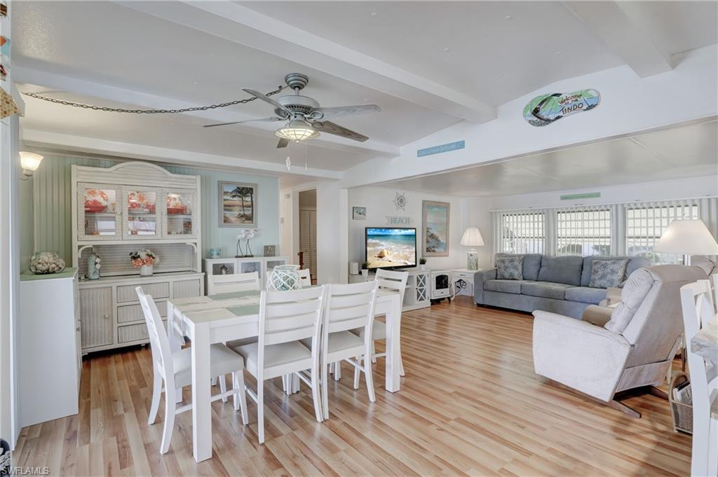 104 Willow Lane, Unit 30 Naples, FL 34114 - Photo 3 of 27 a view of a dining room with furniture and wooden floor
