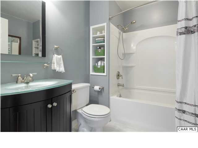4284 Slam Gate Road Crozet, VA 22932 - Photo 9 of 30 a bathroom with a sink a toilet a shower a mirror and a bathtub