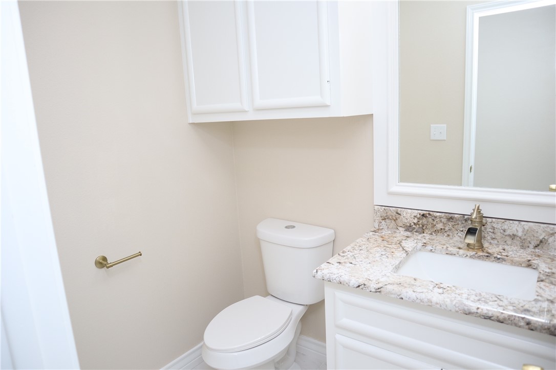 406 Old Robstown Road Corpus Christi, TX 78408 - Photo 12 of 15 a white toilet sitting next to a bathroom sink