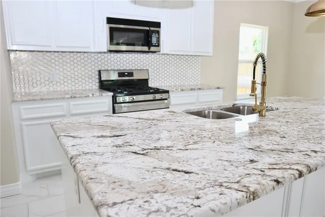 a kitchen with a sink and a microwave