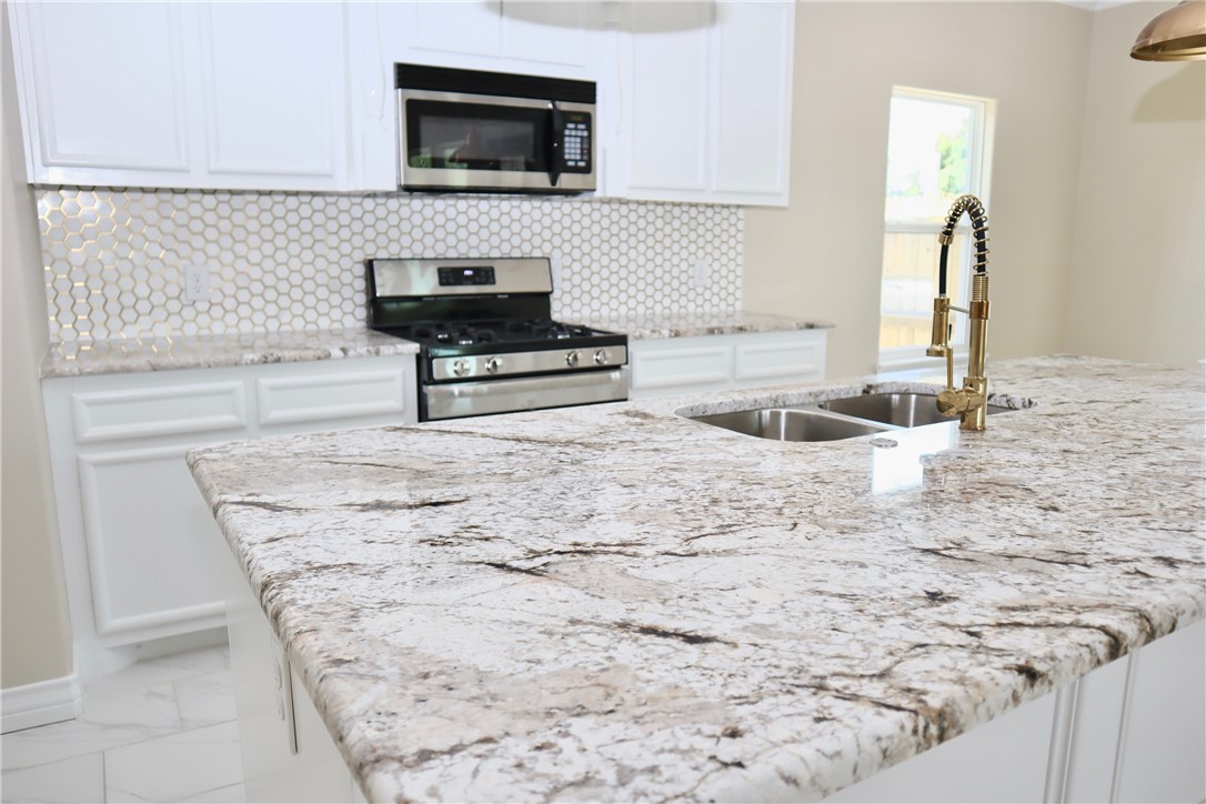 406 Old Robstown Road Corpus Christi, TX 78408 - Photo 3 of 15 a kitchen with a sink and a microwave