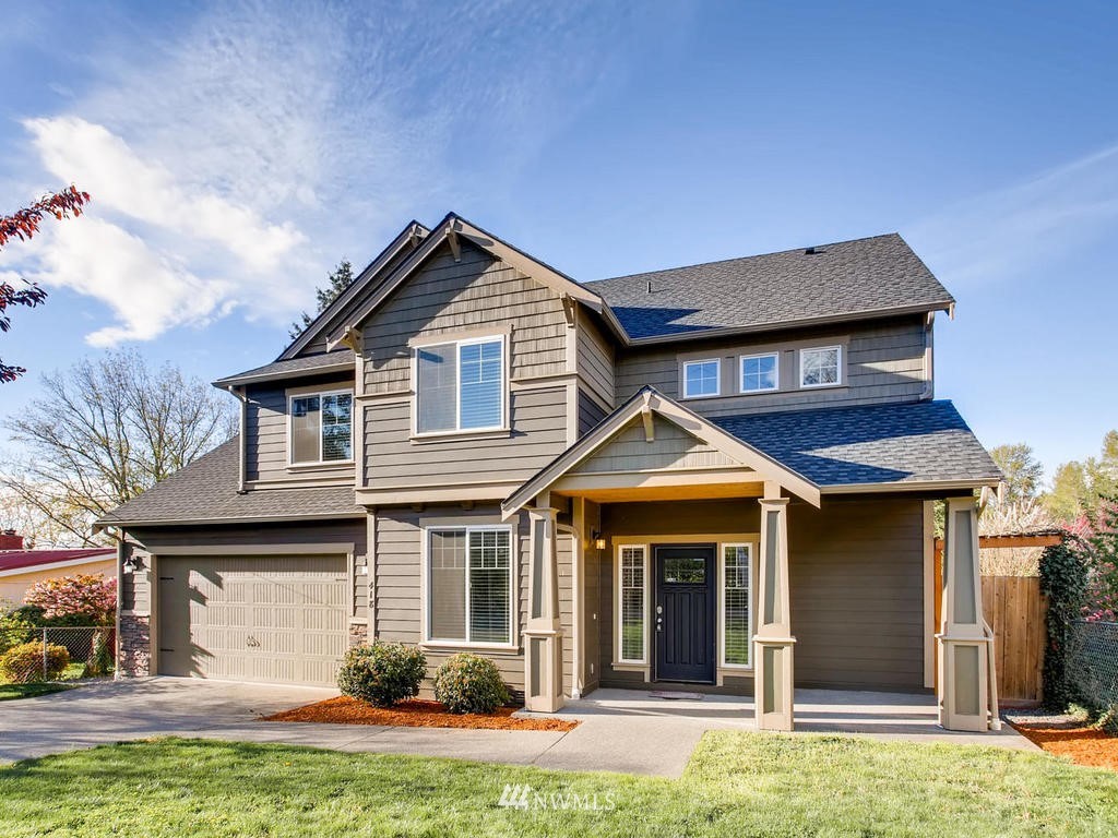 418 South 37th Street Renton, WA 98055 - Photo 1 of 24 a front view of a house with a yard and garage
