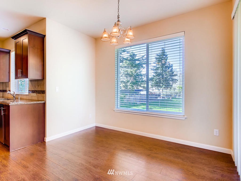 418 South 37th Street Renton, WA 98055 - Photo 11 of 24 a view of an empty room with wooden floor and a window