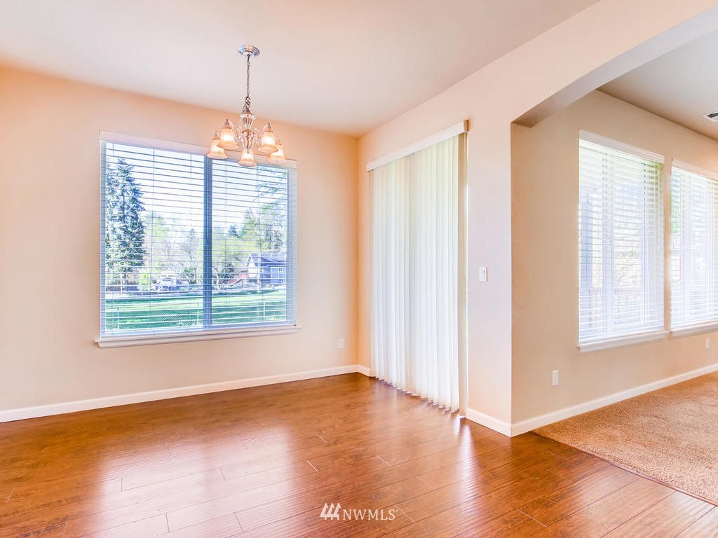 418 South 37th Street Renton, WA 98055 - Photo 12 of 24 a view of an empty room with wooden floor and a window