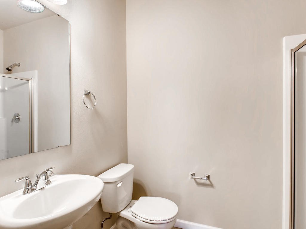 418 South 37th Street Renton, WA 98055 - Photo 14 of 24 a bathroom with a sink a toilet and a mirror