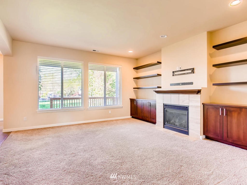 418 South 37th Street Renton, WA 98055 - Photo 4 of 24 a view of empty room with a fireplace and window