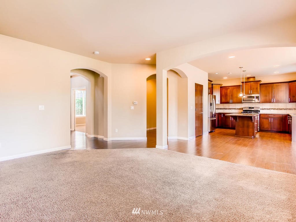 418 South 37th Street Renton, WA 98055 - Photo 6 of 24 a view of a kitchen with kitchen island stainless steel appliances wooden floor and furniture