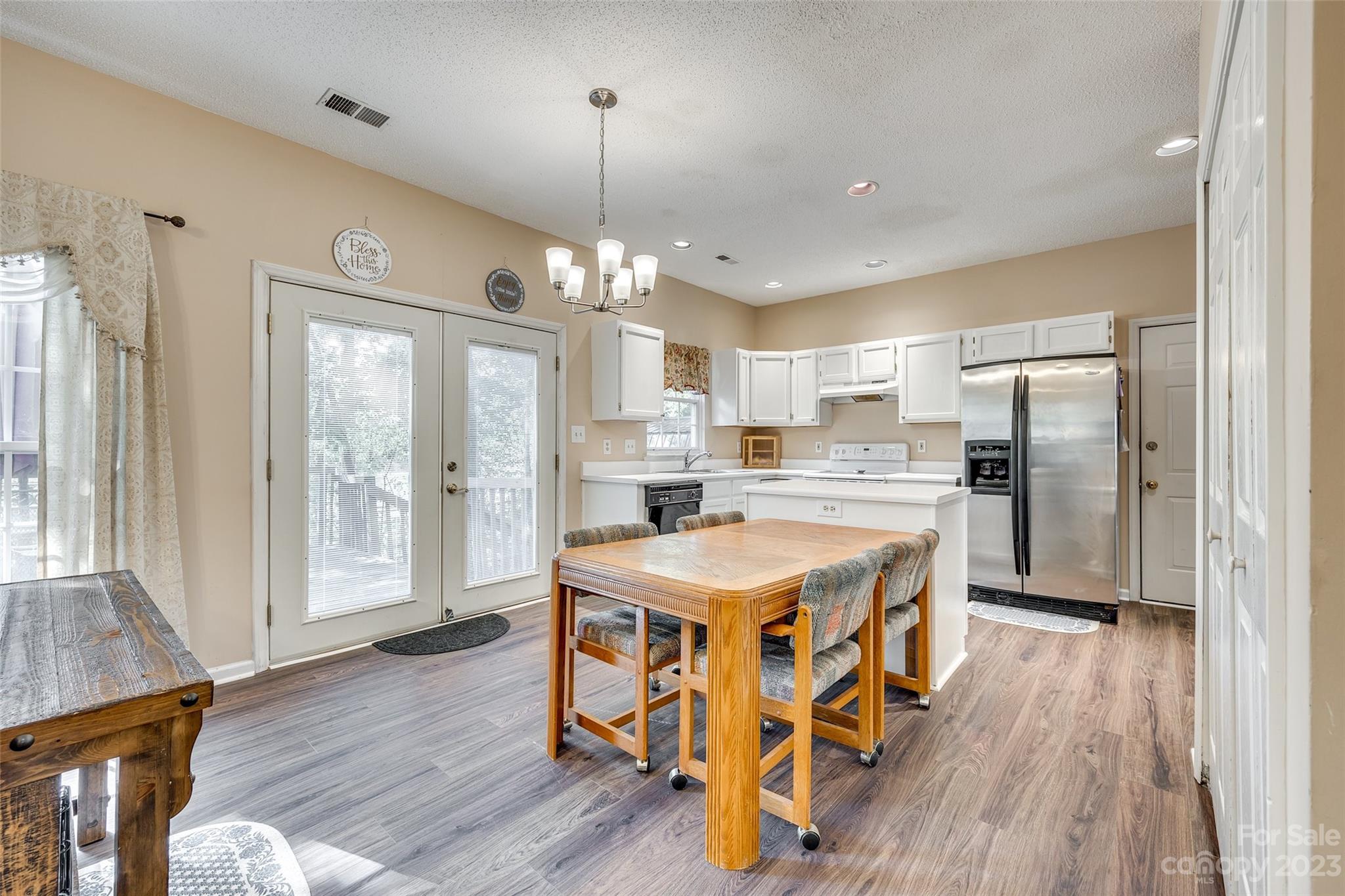 10305 Hatter Ridge Terrace Charlotte, NC 28214 - Photo 11 of 36 a kitchen with stainless steel appliances granite countertop a refrigerator a oven a stove and a wooden floors