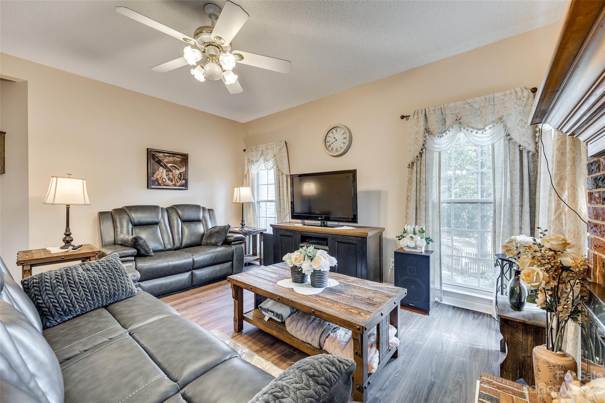 10305 Hatter Ridge Terrace Charlotte, NC 28214 - Photo 13 of 36 a living room with furniture a flat screen tv and a large window
