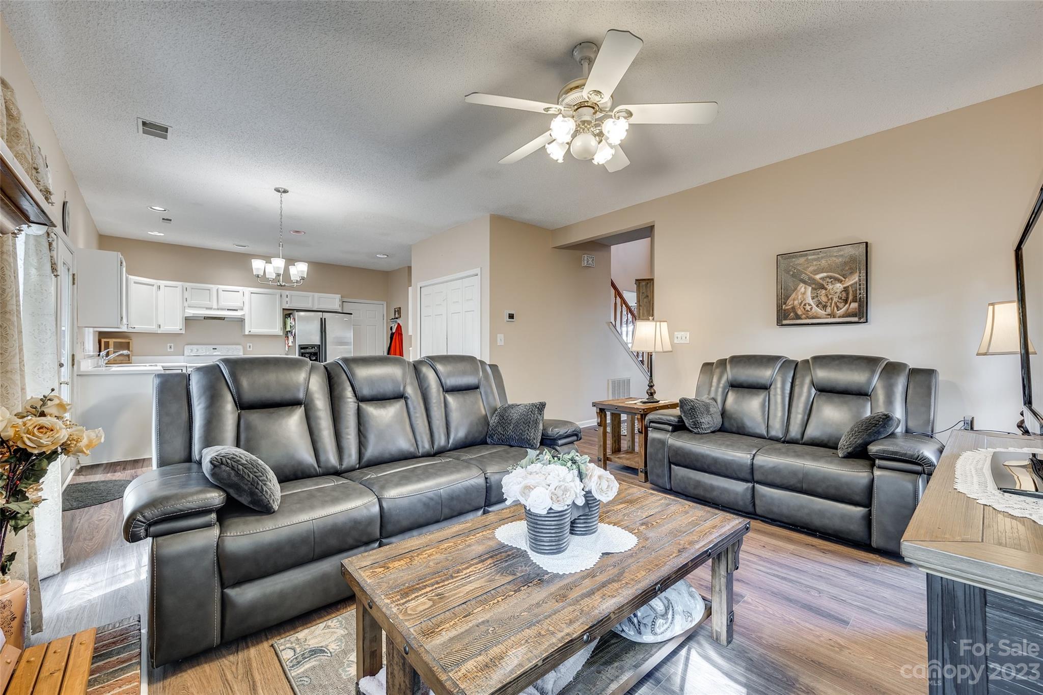 10305 Hatter Ridge Terrace Charlotte, NC 28214 - Photo 15 of 36 a living room with furniture a dining table and chandelier