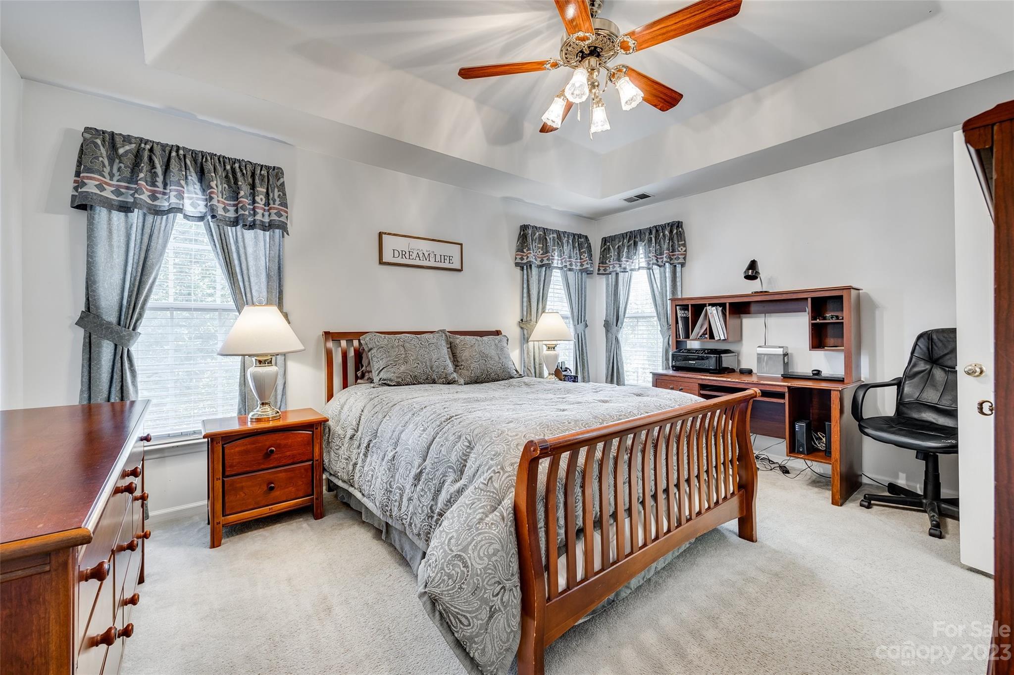 10305 Hatter Ridge Terrace Charlotte, NC 28214 - Photo 19 of 36 a spacious bedroom with a bed and a chandelier