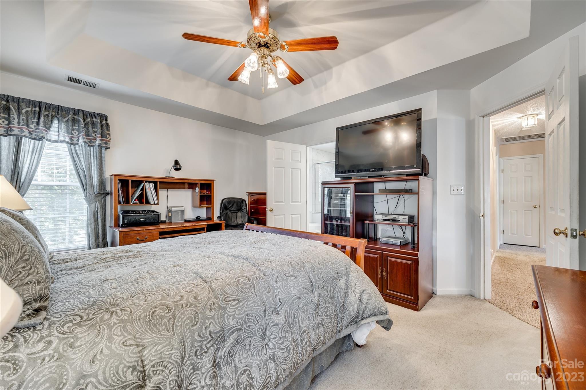 10305 Hatter Ridge Terrace Charlotte, NC 28214 - Photo 21 of 36 a bedroom with a bed and a flat screen tv