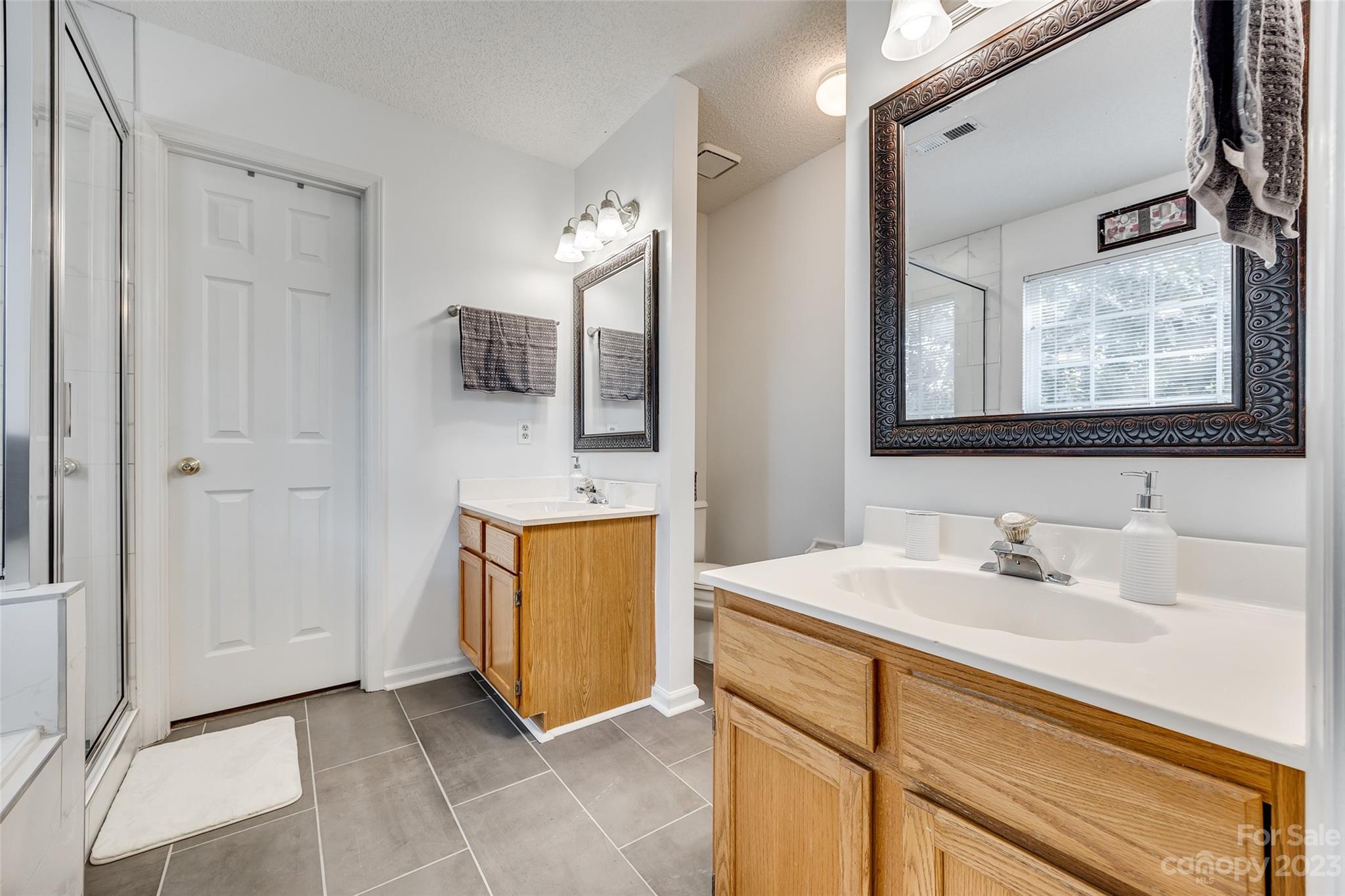 10305 Hatter Ridge Terrace Charlotte, NC 28214 - Photo 22 of 36 a bathroom with a sink and a mirror