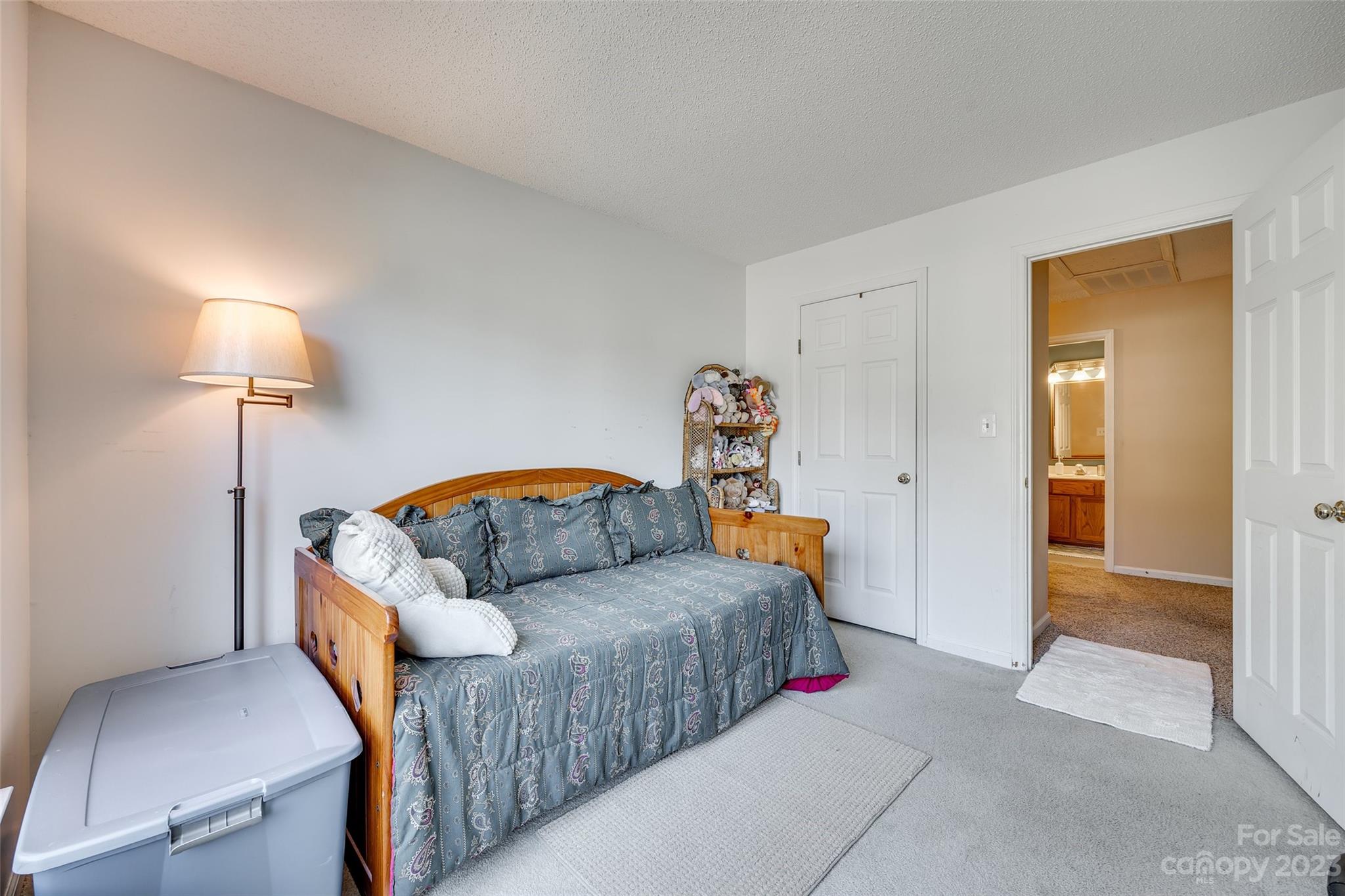 10305 Hatter Ridge Terrace Charlotte, NC 28214 - Photo 26 of 36 a bedroom with a bed and a lamp