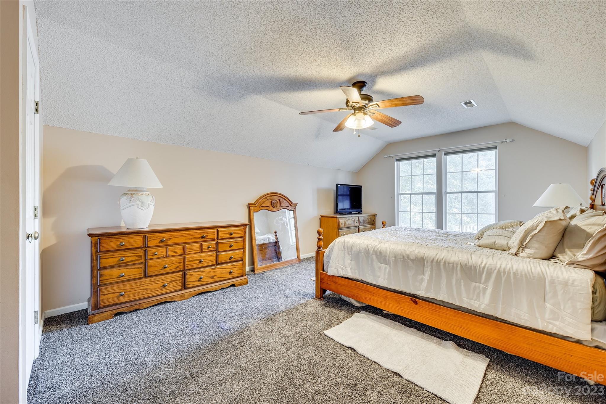 10305 Hatter Ridge Terrace Charlotte, NC 28214 - Photo 27 of 36 a bed room with a bed and a chandelier