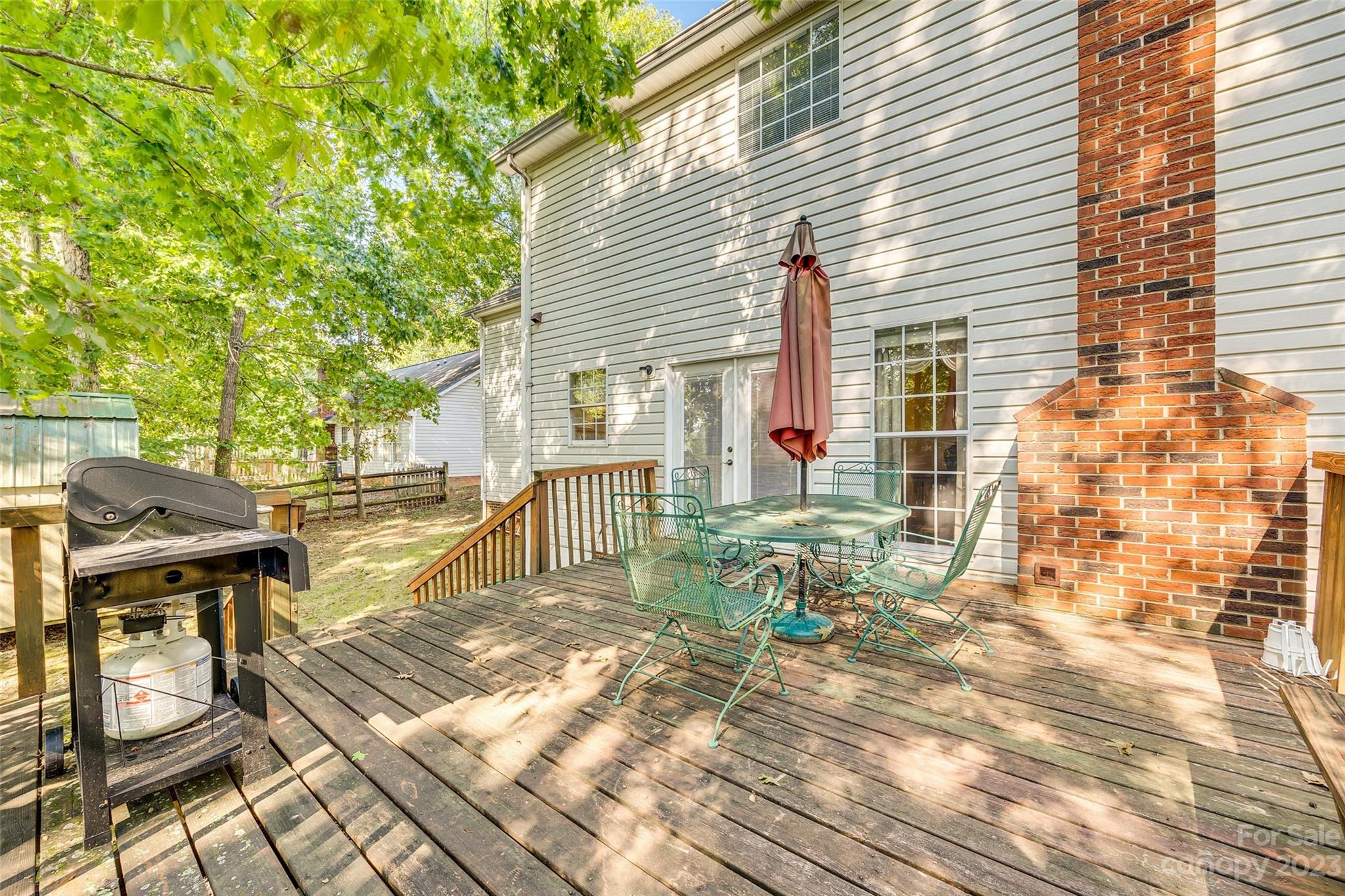 10305 Hatter Ridge Terrace Charlotte, NC 28214 - Photo 30 of 36 a view of a patio with table and chairs and wooden floor