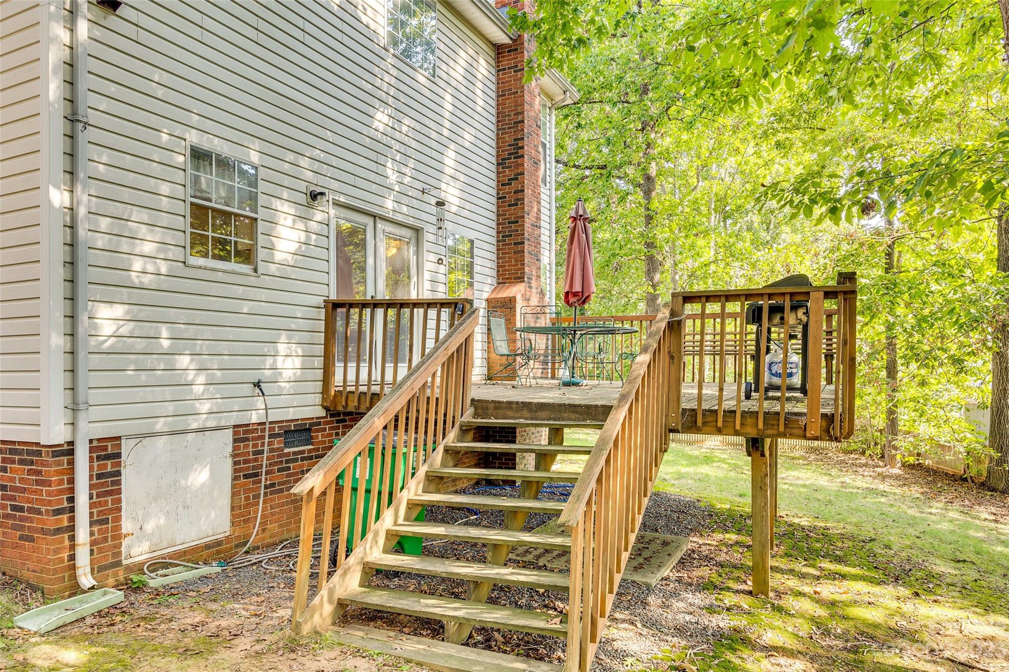 10305 Hatter Ridge Terrace Charlotte, NC 28214 - Photo 31 of 36 a view of staircase with wooden floor and a potted plant