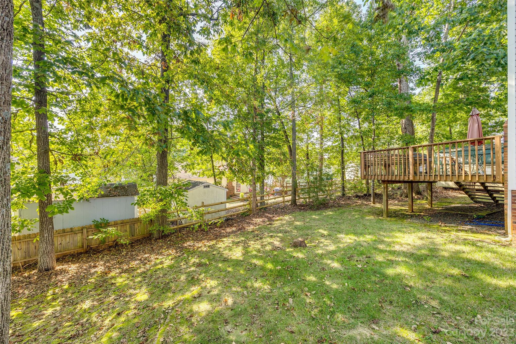 10305 Hatter Ridge Terrace Charlotte, NC 28214 - Photo 34 of 36 a view of backyard with swimming pool and trees