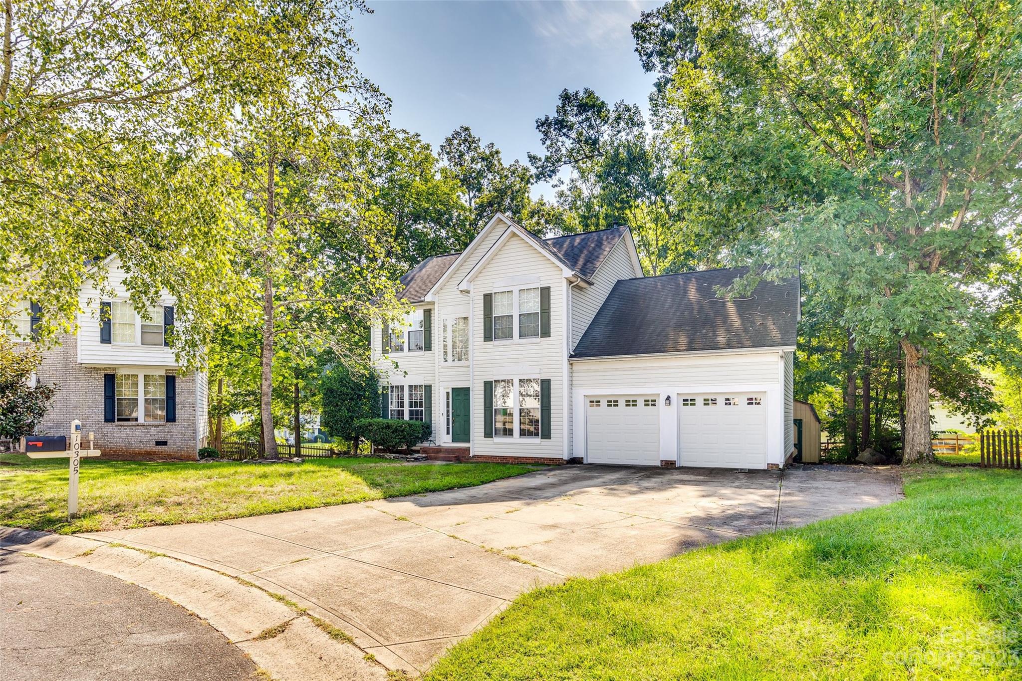 10305 Hatter Ridge Terrace Charlotte, NC 28214 - Photo 35 of 36 a front view of a house with a garden and trees