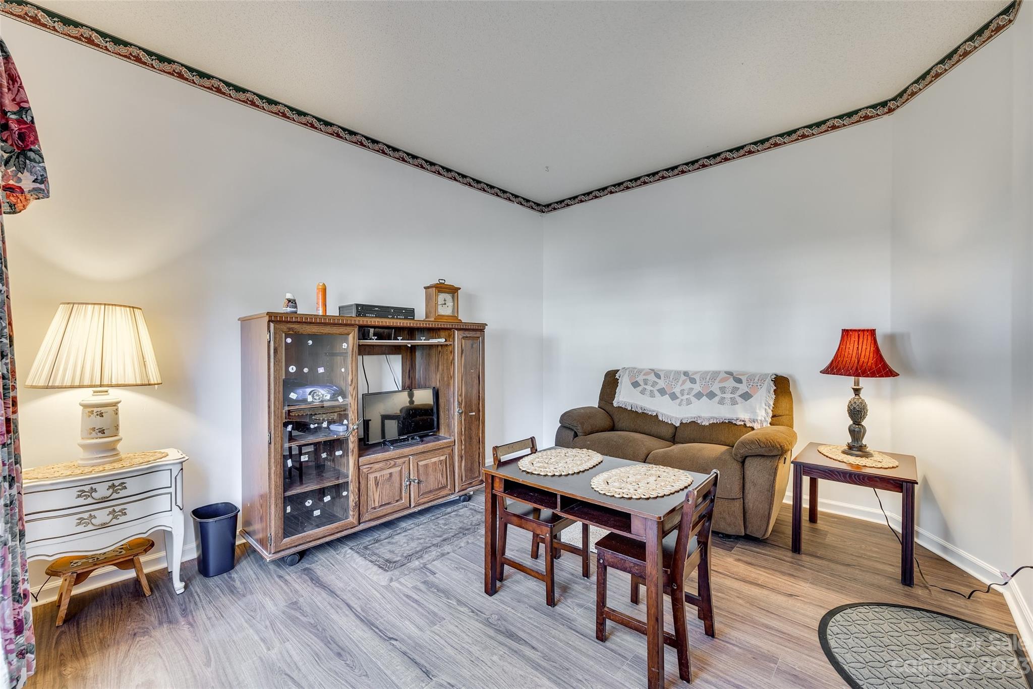 10305 Hatter Ridge Terrace Charlotte, NC 28214 - Photo 5 of 36 a living room with furniture and a wooden floor