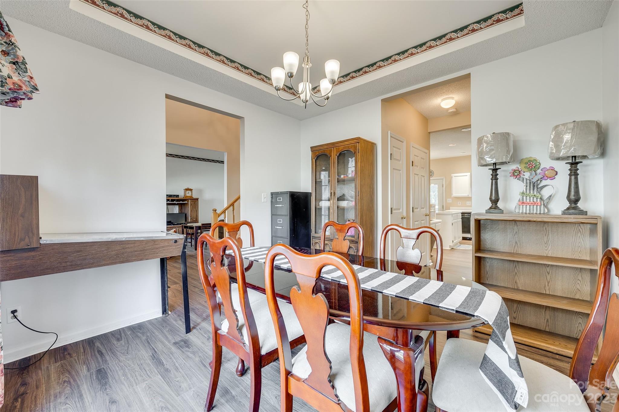 10305 Hatter Ridge Terrace Charlotte, NC 28214 - Photo 7 of 36 a view of a dining room with furniture and chandelier
