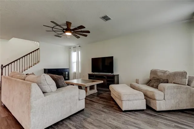 a view of kitchen with refrigerator microwave and wooden floor