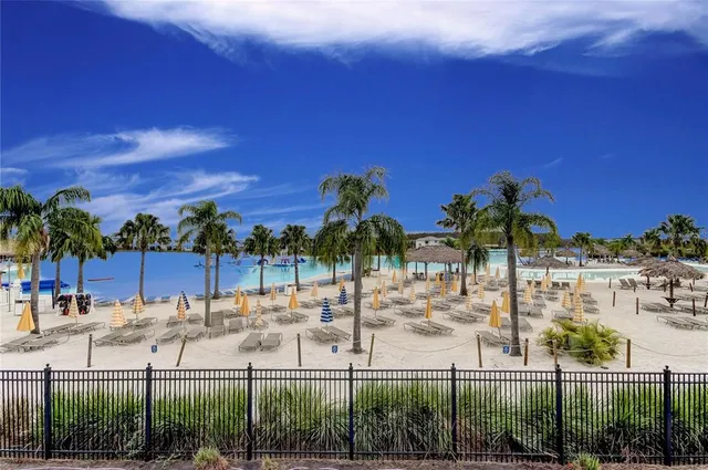 a view of a swimming pool and outdoor seating