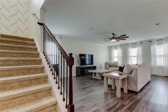 a living room with furniture a wooden floor and a window
