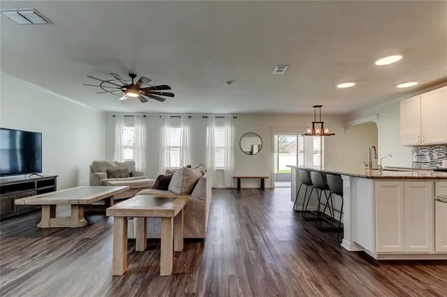 a living room with furniture a window and a flat screen tv