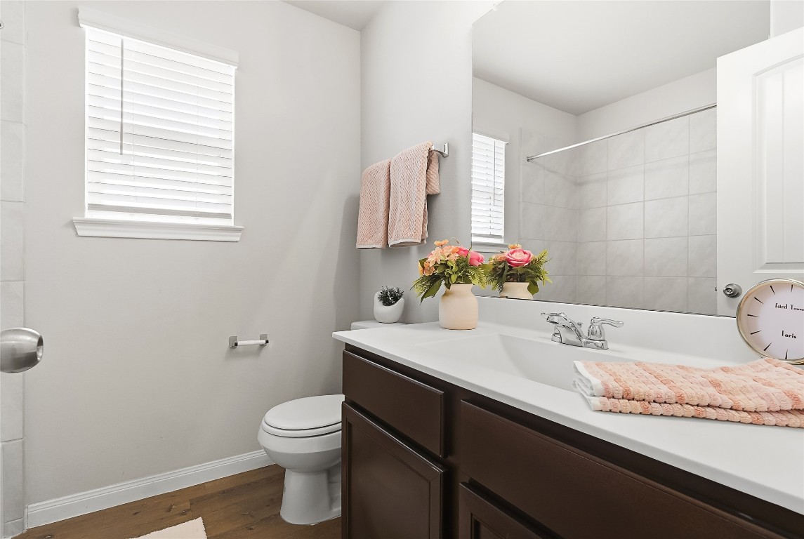 995 Rice Drive Bryan, TX 77803 - Photo 16 of 23 a bathroom with a granite countertop sink a toilet and mirror