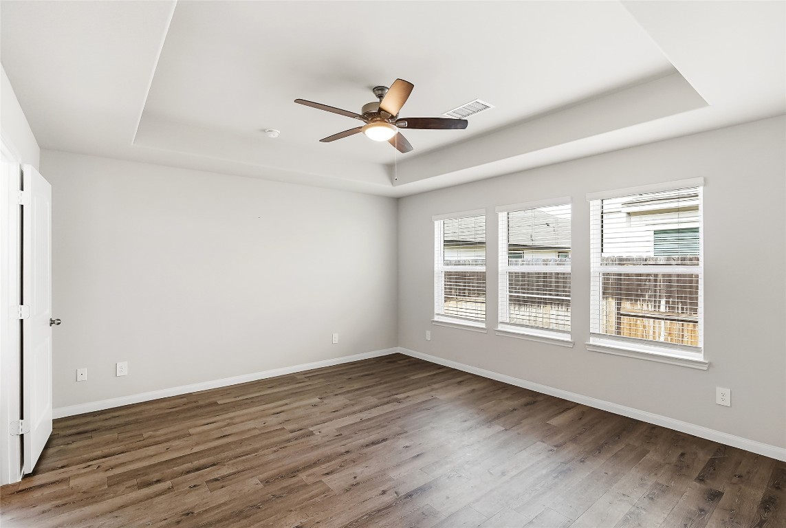 995 Rice Drive Bryan, TX 77803 - Photo 18 of 23 an empty room with wooden floor fan and windows