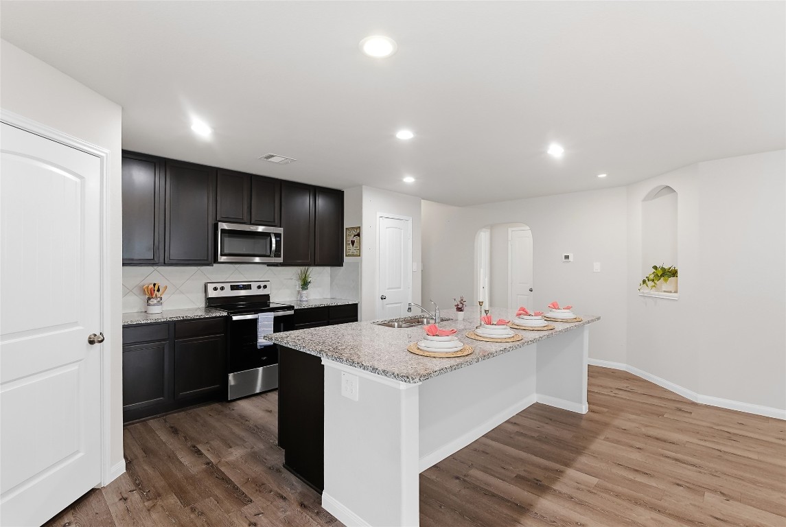 995 Rice Drive Bryan, TX 77803 - Photo 2 of 23 a kitchen with sink a microwave and refrigerator