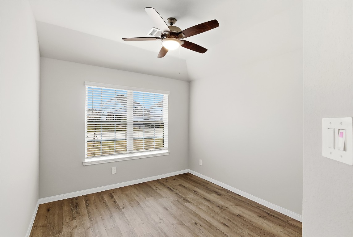 995 Rice Drive Bryan, TX 77803 - Photo 23 of 23 a view of an empty room with wooden floor and a window