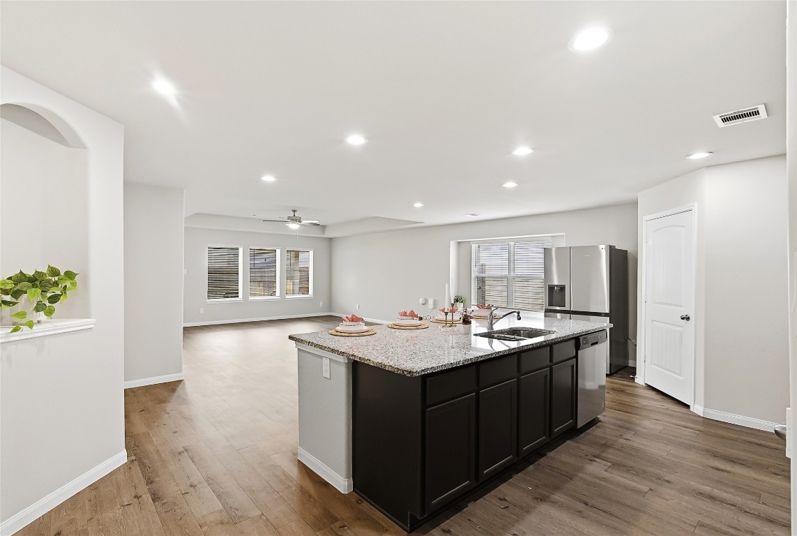 995 Rice Drive Bryan, TX 77803 - Photo 6 of 23 a kitchen with a sink and stove with wooden floor