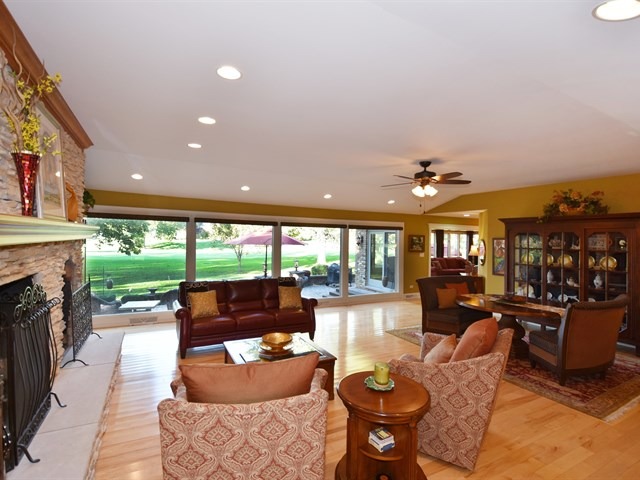 575 Aberdeen Road Frankfort, IL 60423 - Photo 7 of 25 a living room with furniture a fireplace and a floor to ceiling window